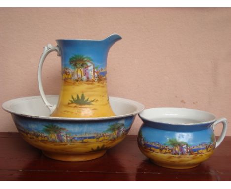 An early 20th Century wash jug basin and pot decorated with Egyptian scenes. 