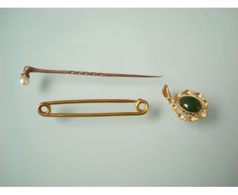 A 15 carat black opal doublet and green nephrite revolving pendant together with a 9 carat gold pearl set stick pin and a 9 c