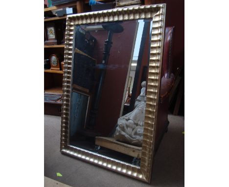 A modern silver framed rectangular wall mirror. 