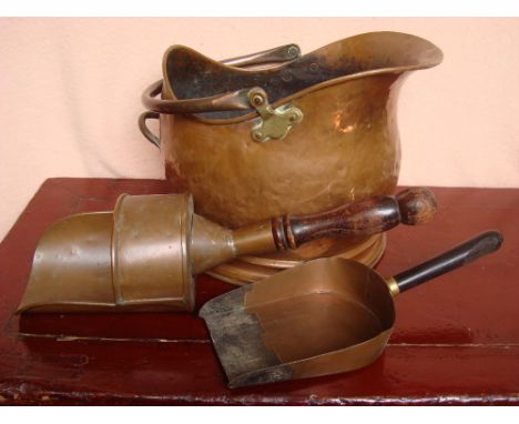 A 19th Century copper helmet coal scuttle and two scoops. 