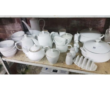 SHELF OF WHITE CERAMIC TABLEWARE 