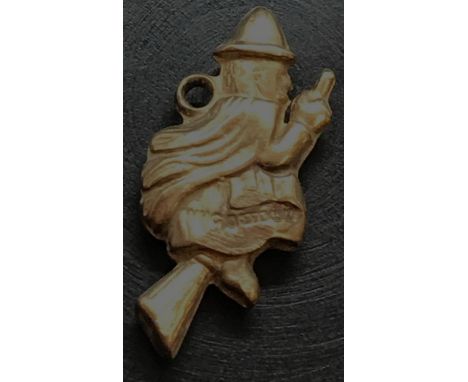 A 9ct GOLD CHARM OF A WITCH ON BROOM STICK