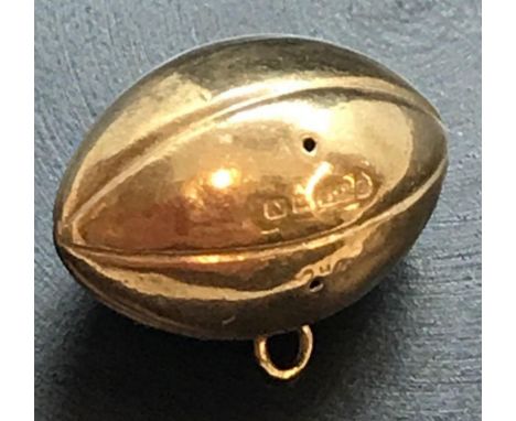 A 9CT GOLD CHARM IN FORM OF A RUBY BALL