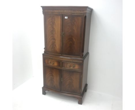 Reproduction Bevan Funnell mahogany serpentine front cocktail cabinet, two cupboards enclosing fitted shelves, single slide a