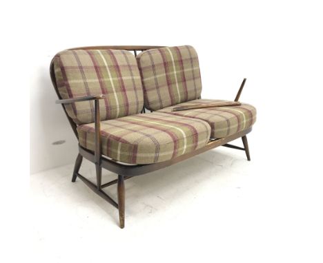 Ercol beech two seat Windsor settee, upholstered back and seat, turned supports, W130cm - Condition Report One arm detached b