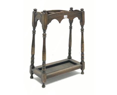 Early 20th century oak stick and umbrella stand, three divisions, turned supports, with metal drip tray, W52cm, H70cm, D25cm 