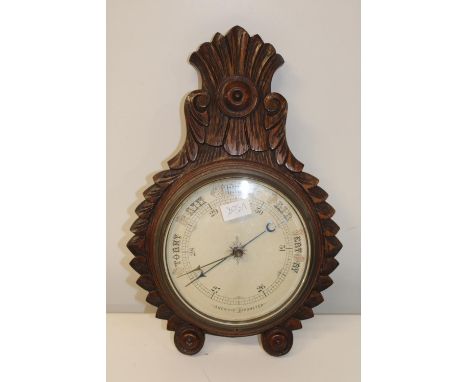 A oak framed aneroid barometer 48cm in length 