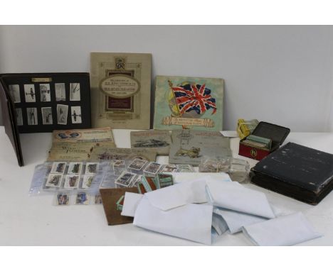 A box of vintage cigarette card albums and loose cards 