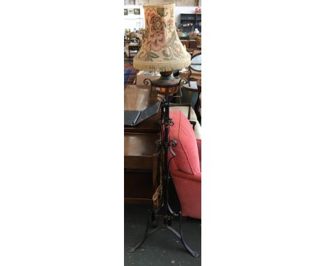 A wrought iron standing oil lamp, converted for electrical use 