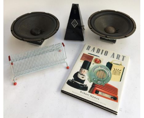 A mechanical metronome; together with a pair of 10" speaker cones; a CD rack and 'Robert Hall's Radio Art' book 