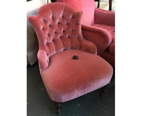 A small button back bedroom chair on casters 