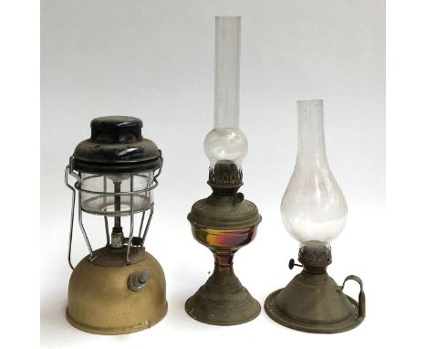 Two oil lamps, one with loop carry handle, both with glass chimneys, the taller 49cmH; together with a Pyrex tilley lamp 
