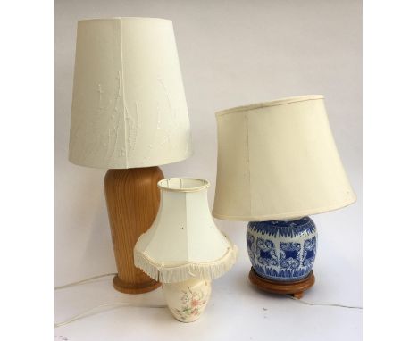 A blue and white ginger jar converted as a table lamp;  together with a large turned wooden table lamp and one other 