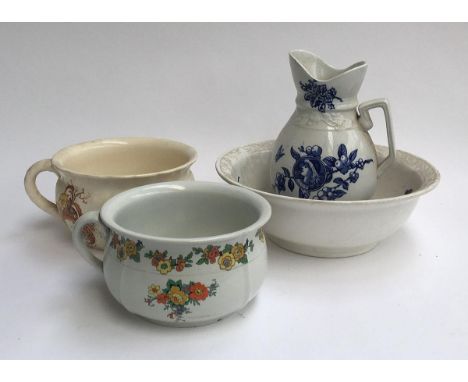 A large washbowl and jug, together with two ceramic chamber pots 