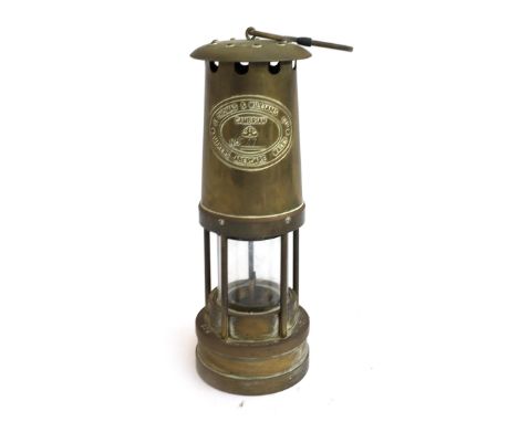 A brass 20th century Thomas &amp; Williams 'Cambrian' miner's lamp, cylindrical with glass centre, plaque reads 'no.247255', 