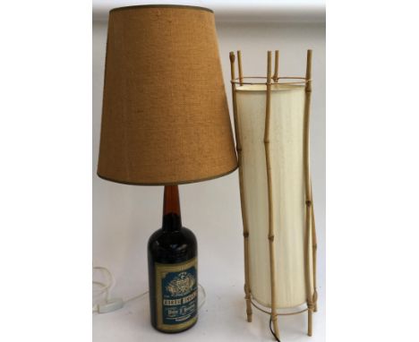 A 'Cherry Heering' bottle converted table lamp, with 1970s style shade; together with one other bamboo floor lamp 