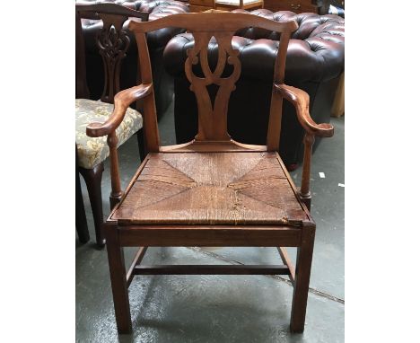 A Georgian mahogany commode chair, with rush seat and ceramic chamber pot, on square section legs with H-stretcher 