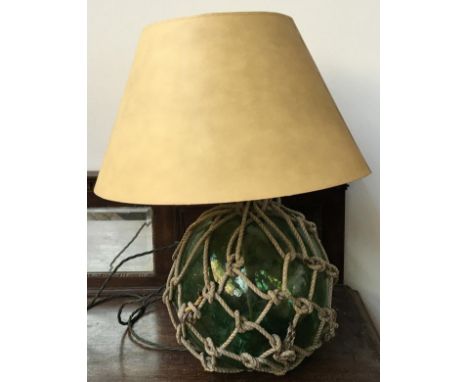 A green glass table lamp in the form of a fisherman's float, with shade, height to top of shade approx. 63cm 