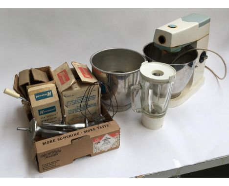 A vintage Kenwood mixer with various bowls and attachments 