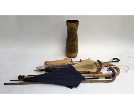 A number of vintage umbrellas and walking sticks; together with a large studio pottery umbrella stand 