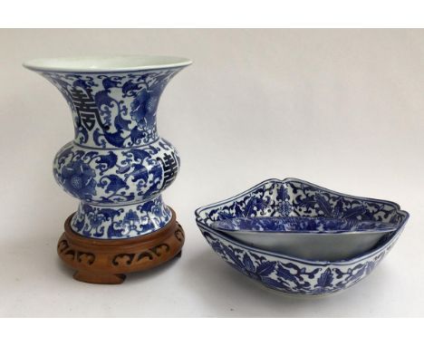 A blue and white Oriental vase on carved hardwood stand, 25cmH; together with two blue and white ceramic bowls 