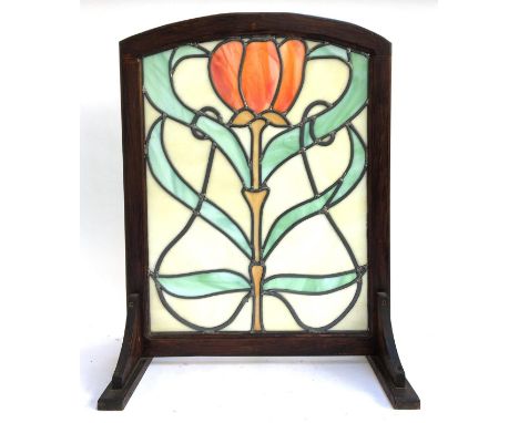 An Art Nouveau style glazed fire screen, set within an oak frame, 71cmH 