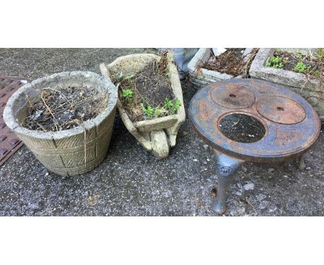 A composite stone planter in the form of a wheelbarrow, together with one other; and a 'Con' cast iron tripod stand 