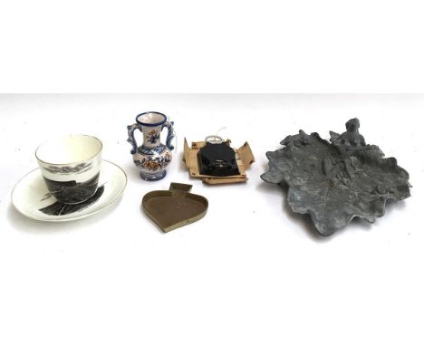 An Indian incense burner; folding compass; pewter Art Nouveau style tray; West Bay souvenir cup and saucer 