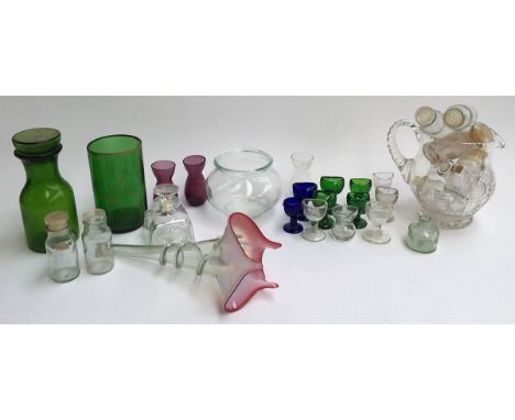 Mixed lot of glassware to include 12 eye baths, cut glass jug, vintage glass jars and bottles, vases, etc 