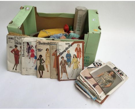 A mixed box of knitting paraphernalia and vintage sewing patterns 