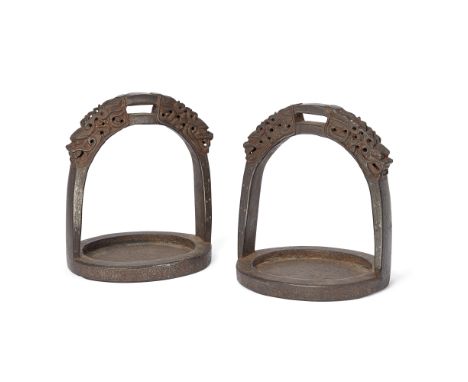 A pair of Chinese silver-damascened stirrupsQing dynasty, 17th/18th centuryCast with two dragon heads to the top and inlaid w