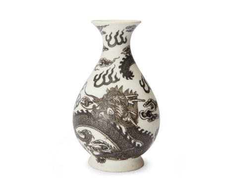 A small Chinese biscuit porcelain 'dragon' pear-shaped vase, yuhuchunpingLate Qing dynasty, apocryphal Kangxi six-character m