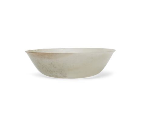 A Chinese white jade shallow bowlQing dynasty, 18th/19th centuryThinly carved from a pale, translucent stone with cloudy-whit