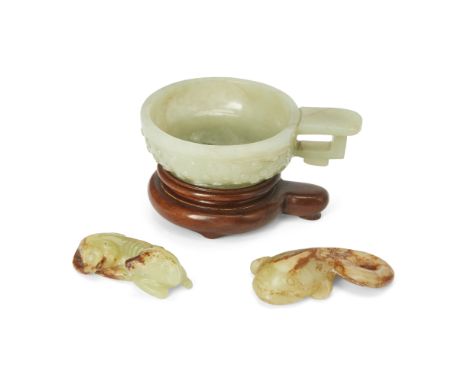 A group of three Chinese jadesLate Qing dynastyComprising: a pale celadon Han-style handled cup, 8.5cm wide; a yellow and rus
