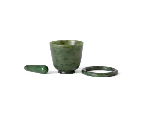 Three Chinese spinach jade carvingsEarly 20th centuryComprising: a spinach jade cup with short splayed foot rising to deep si