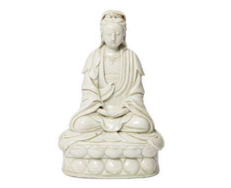 A Chinese blanc-de-chine figure of GuanyinMing/Qing dynasty, 17th centuryFinely modelled seated in dhyansana on a lotus base 