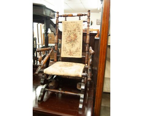 A CHILD'S EARLY 20TH CENTURY AMERICAN-TYPE PLATFORM ROCKING CHAIR WITH FLORAL TAPESTRY FABRIC PADDED BACK AND SEAT