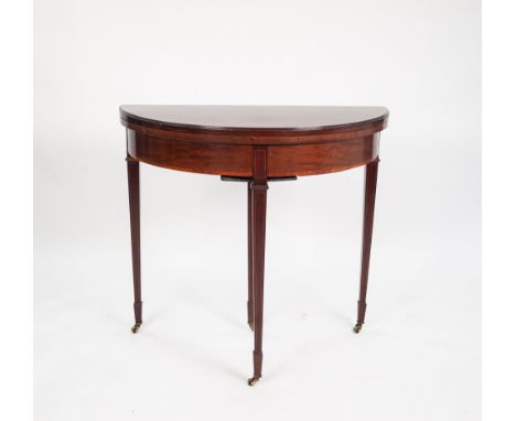 EDWARDIAN SATINWOOD CROSSBANDED MAHOGANY DEMI-LUNE FOLD-OVER CARD TABLE, standing on three square tapered legs ending in spad