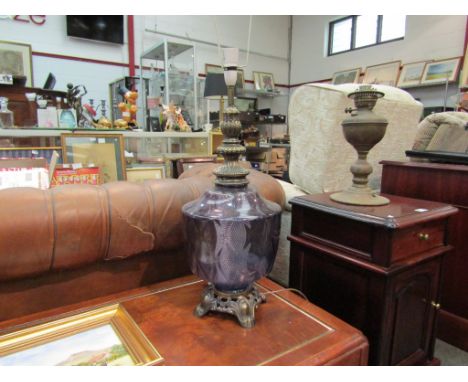 An amethyst coloured glass table lamp on metal footed base (no shade)