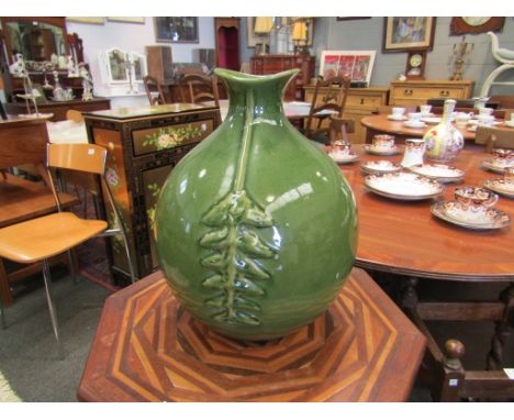 A green bulbous form ceramic vase, 37cm high