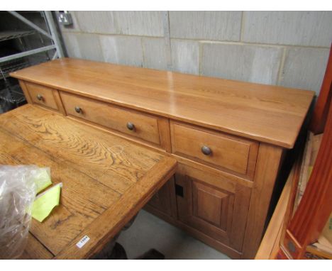 A 20th Century light oak three drawer, four door sideboard, 95cm tall x 197cm x 48cm