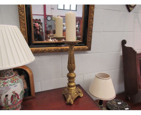 A gilt wooden candlestick, 49cm tall