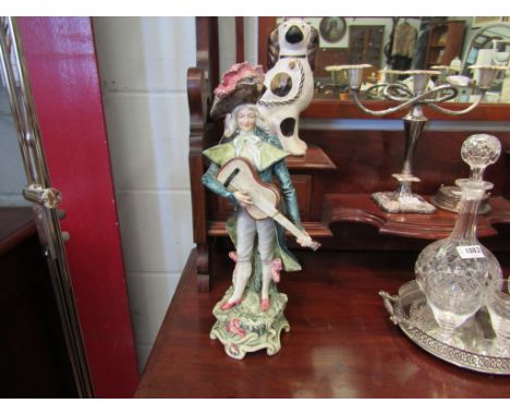 A Continental figure playing the guitar a/f, 41cm tall