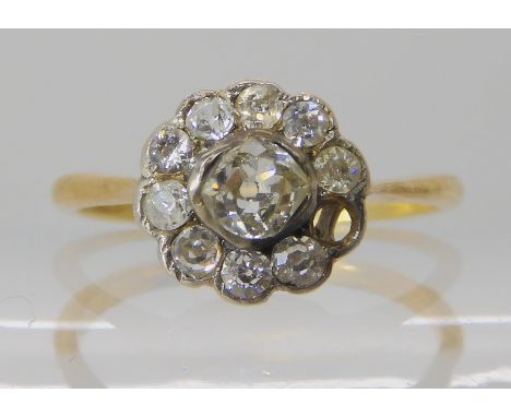 An 18ct diamond flower cluster ring set with estimated approx 0.47cts (as is one diamond missing) size N1/2, weight 2gms Cond