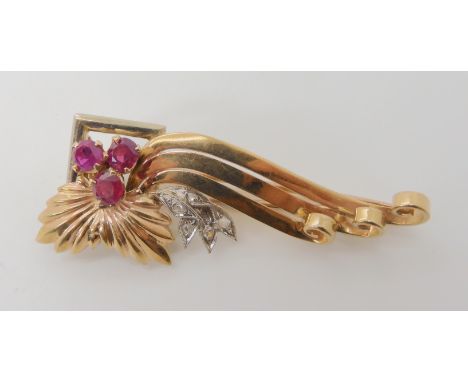 A 9ct gold and platinum diamond and ruby brooch, length 5.3cm, weight 8.9gms Condition Report: Available upon request