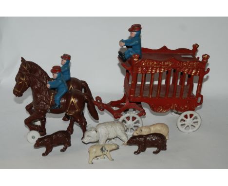A vintage cast-iron Overland Circus horse drawn wagon with figures and bears, 40cm long overall Condition Report: Available u