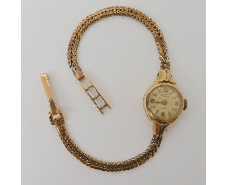 A 9ct gold ladies Rotary Maximus watch with integral herringbone pattern strap, length 17.5cm, diameter of the case 1.5cm, we