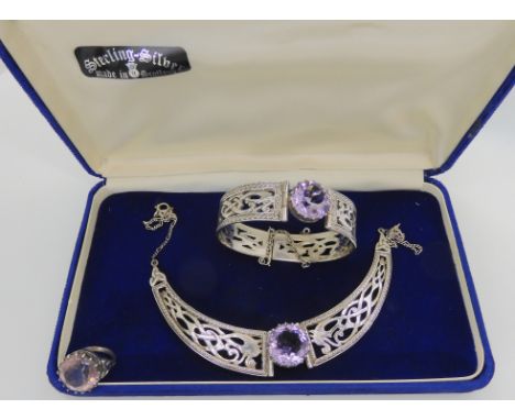 A silver Hamish Dawson Bowman suite of Celtic knotwork dragon, amethyst set jewels, comprising of a necklet, bangle and ring 