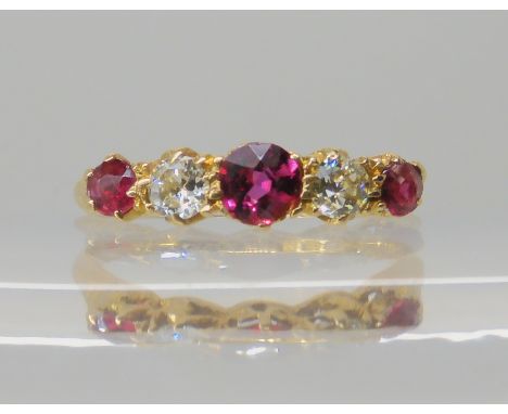 An 18ct gold ruby and diamond ring with scrolled setting, hallmarked London 1918, weight 2.4gms Condition Report: Available u