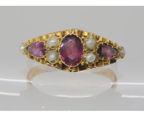 A Victorian 15ct gold ring set with red gems and pearls, hallmarked 1872, finger size P1/2 , weight 2.1gms Condition Report: 